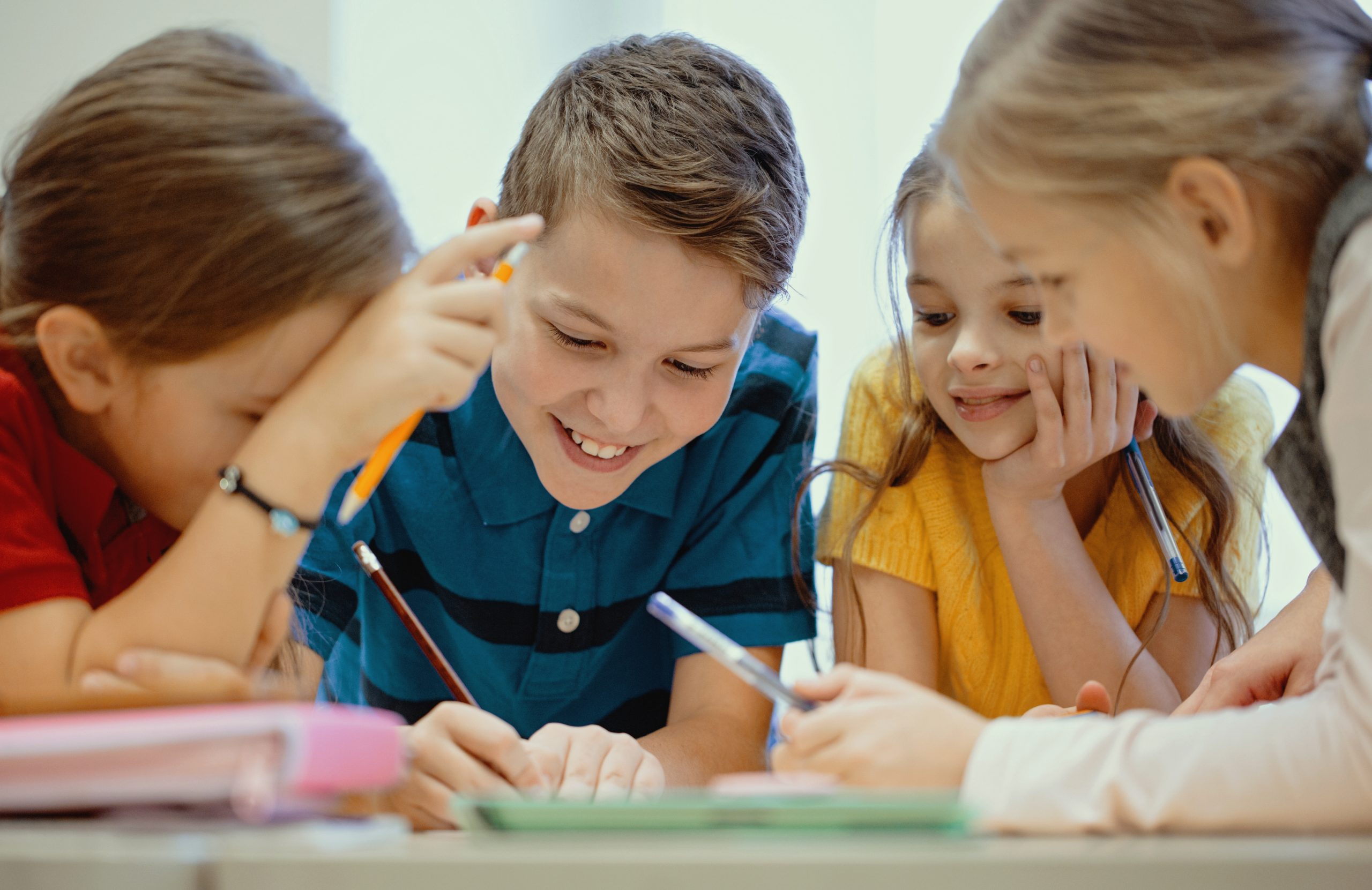 group of students talking and writing at school Studenti alla scuola media paritaria — San Francesco di Sales, Città di Castello